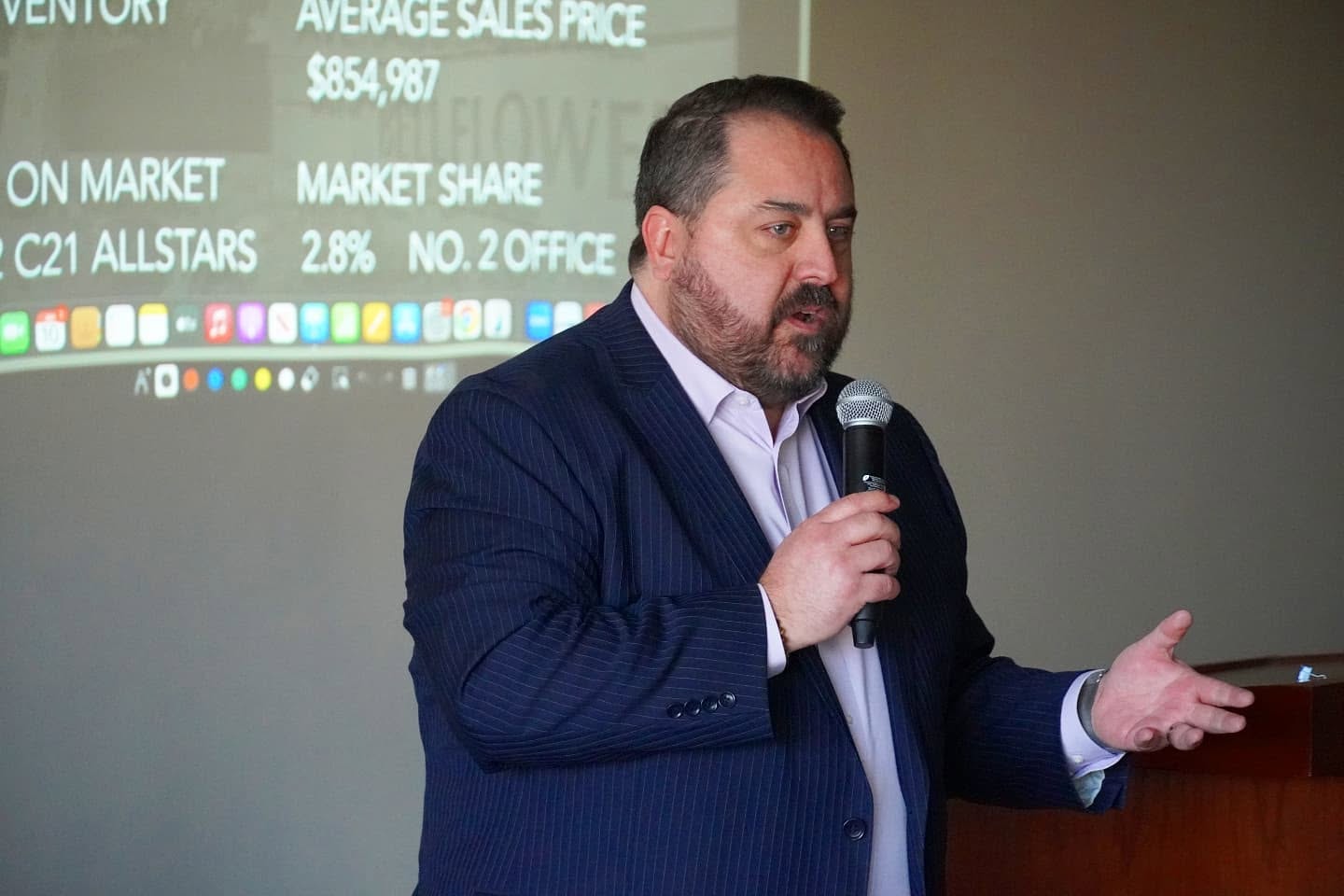 Kyle Estrada teaching real estate professionals with a microphone